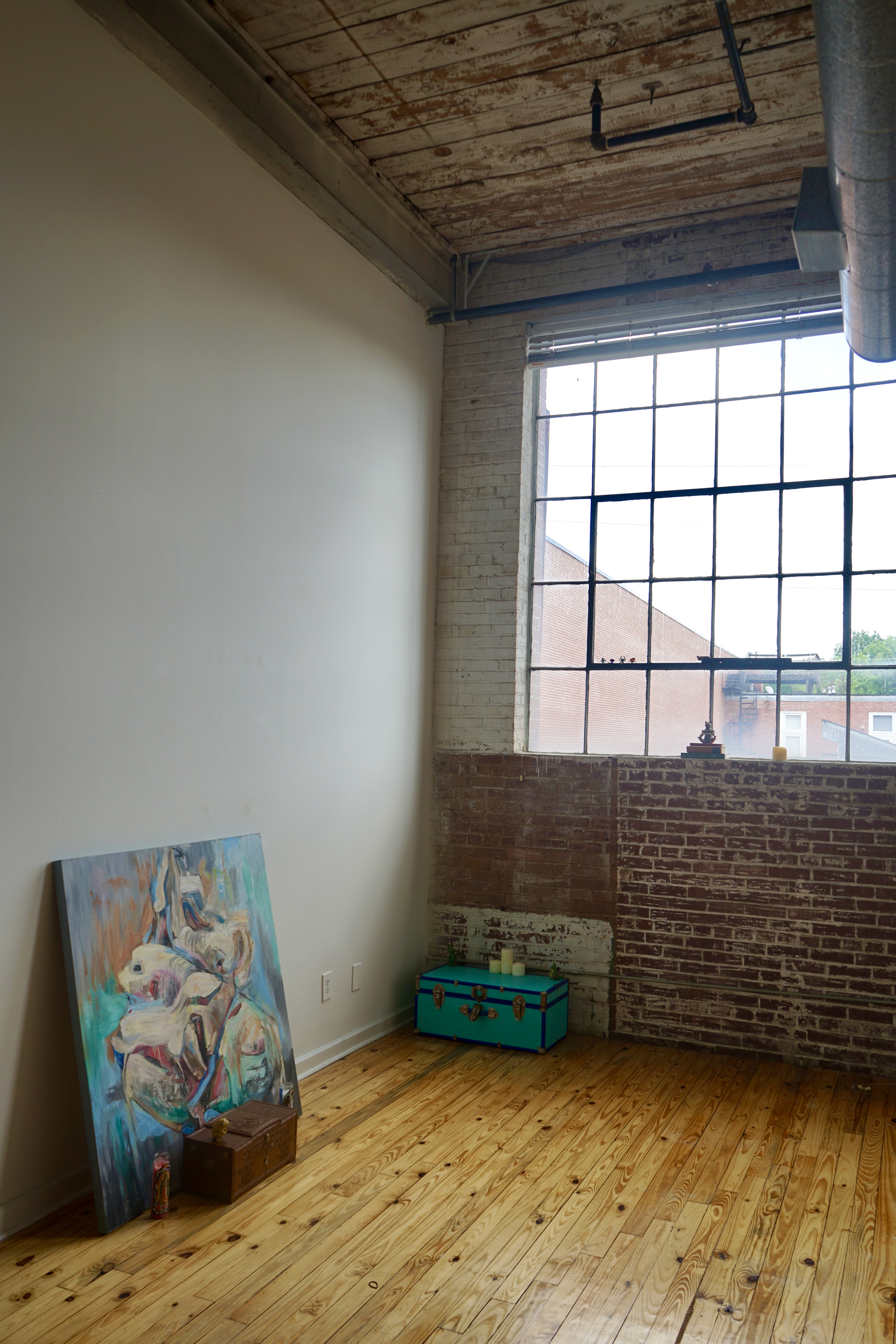Sunny Studio with White Walls and Exposed Brick