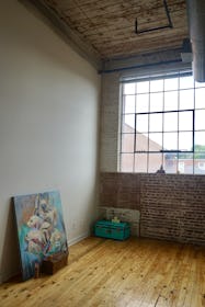 Sunny Studio with White Walls and Exposed Brick