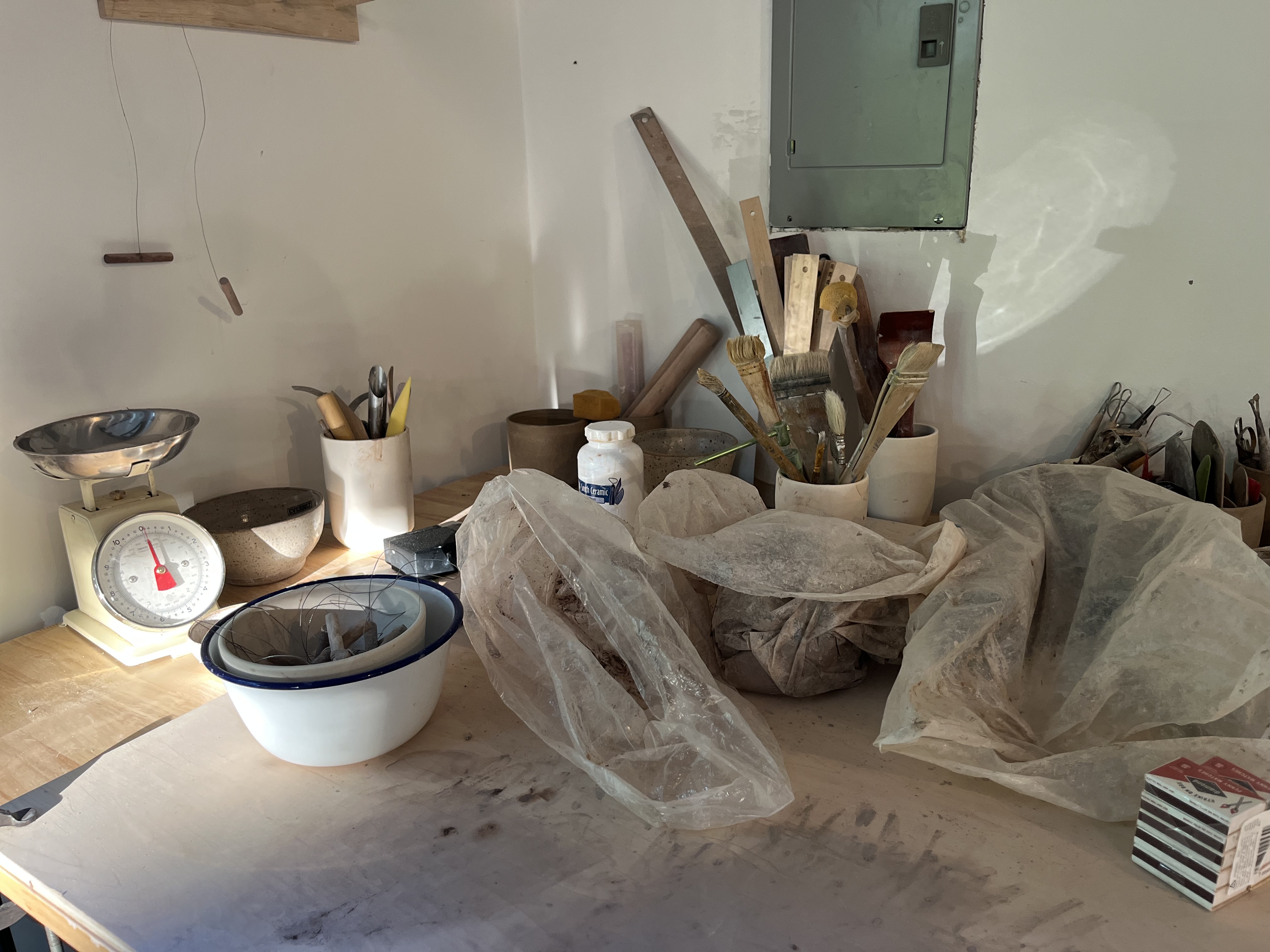 Bright ceramics studio with a hillside view