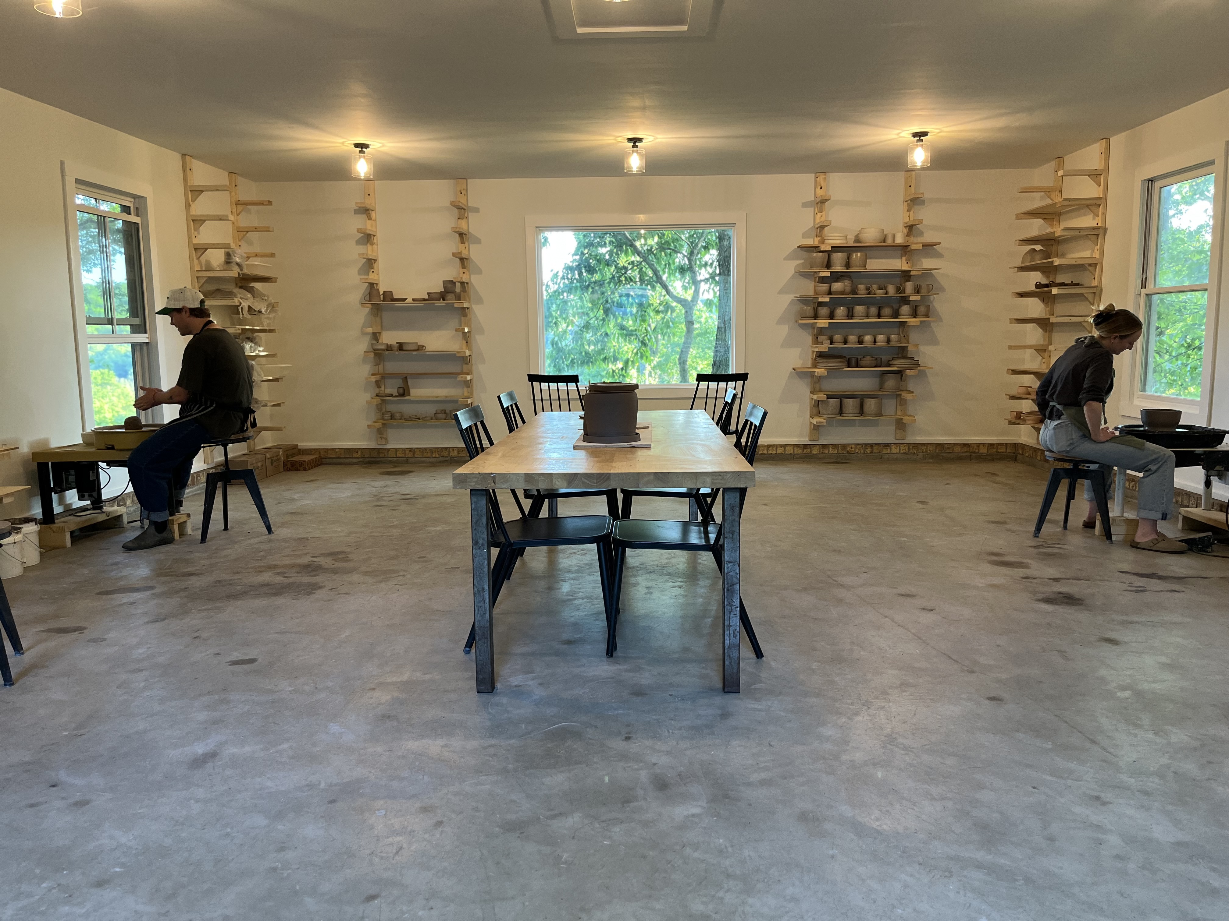 Bright ceramics studio with a hillside view